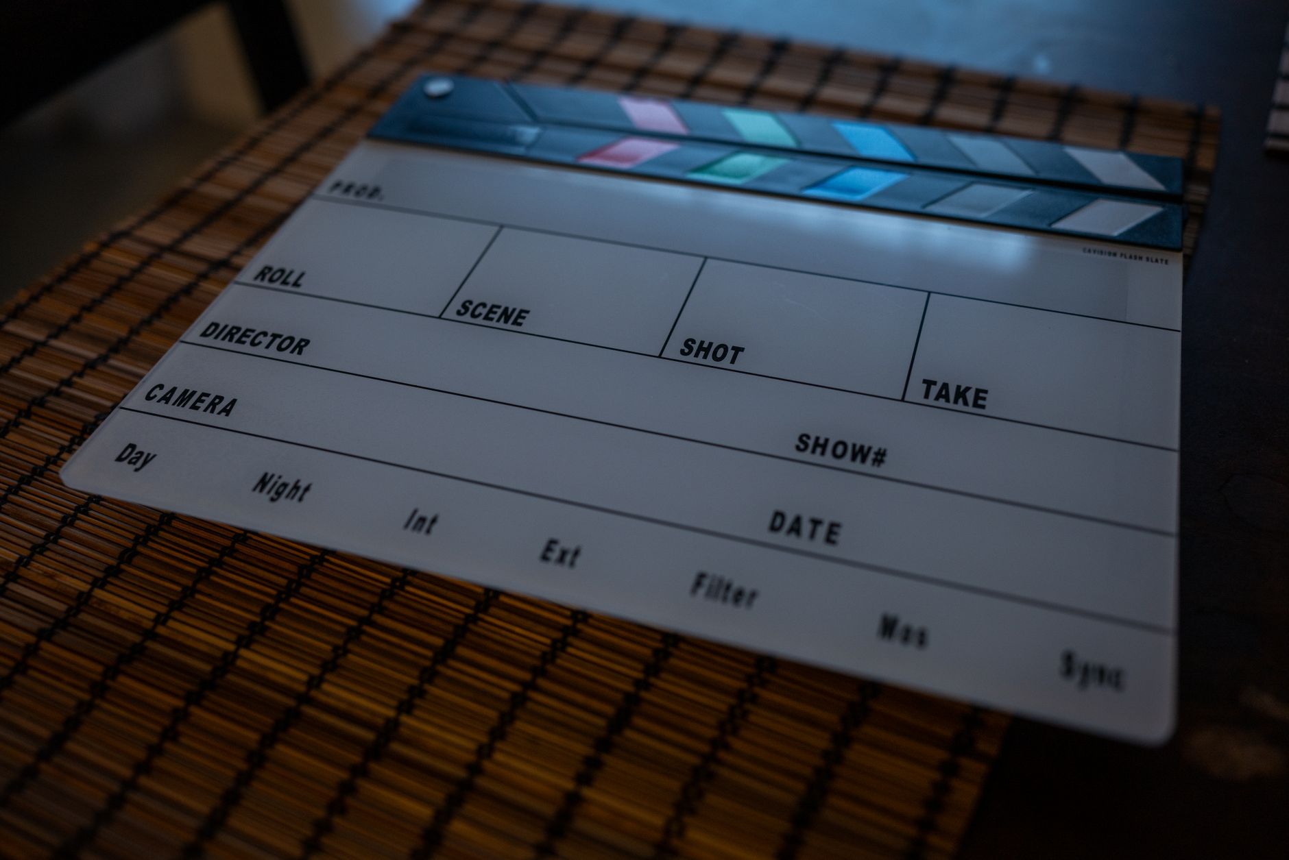 Close-up of a film clapperboard on a bamboo mat, ideal for filmmaking concepts.